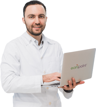 Young adult male in a white lab coat, holding a silver laptop that says "EarliPoint" on it.